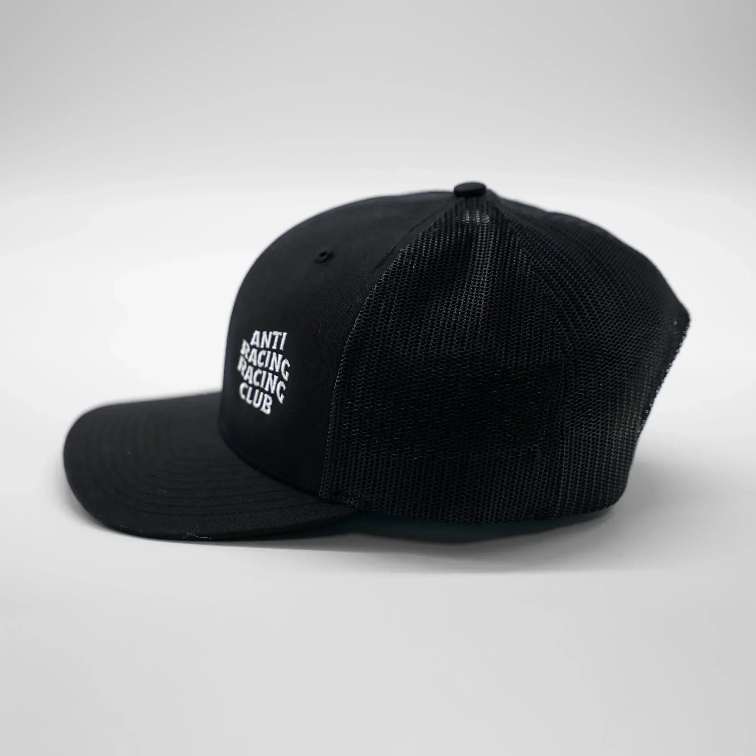 Black cap with white text on a light gray background