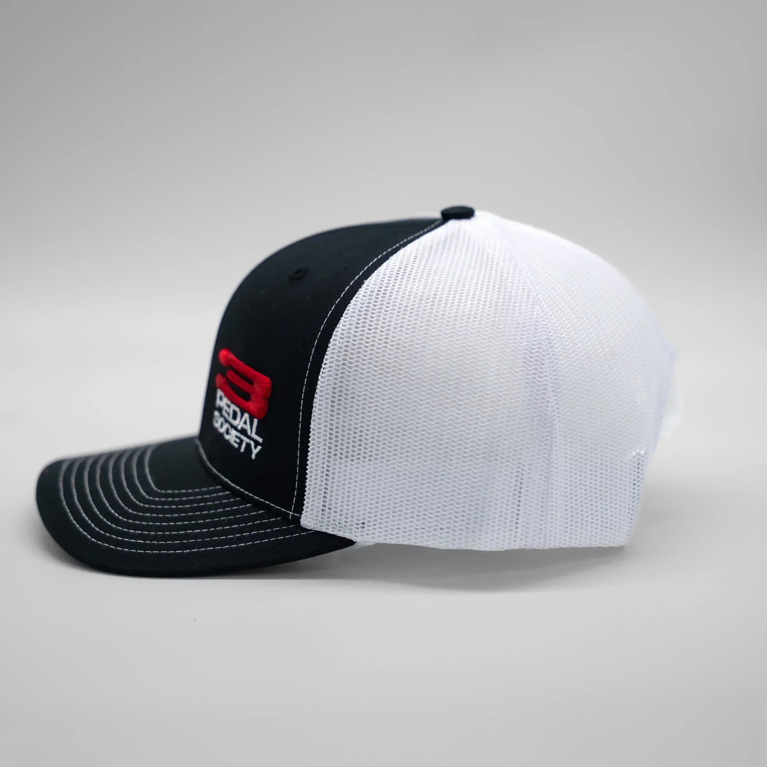 Black and white cap with ' 3 Pedal Society' logo on a gray background