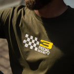 Person wearing a green t-shirt with 'Pedal Society' logo