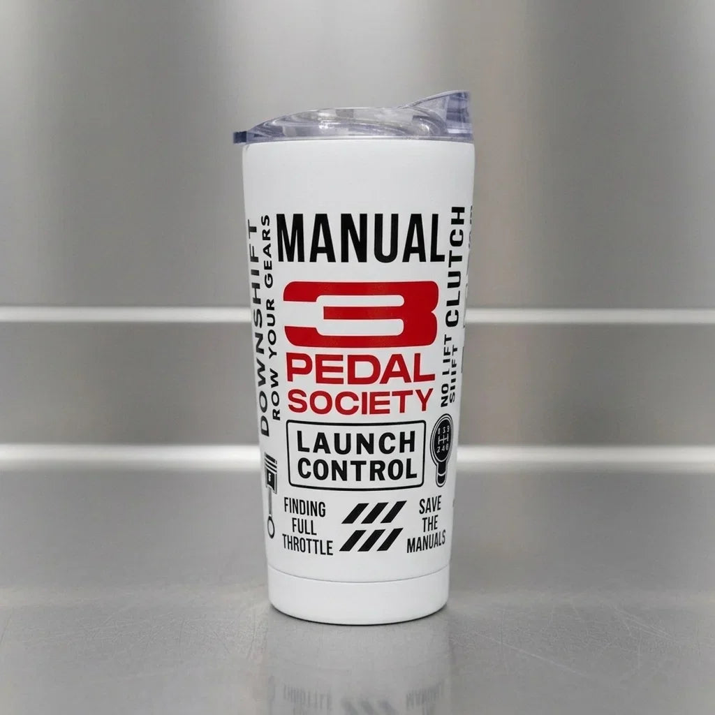 A white insulated tumbler with a clear lid, featuring a red and black '3 Pedal Society' logo and text on the front, set against a gray metallic background.
