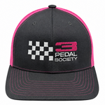 A black trucker-style cap with bright pink mesh side panels and matching pink stitching on the brim. The front features a white and pink embroidered logo that reads '3 PEDAL SOCIETY' alongside a checkered flag graphic.