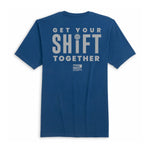 A blue short-sleeve t-shirt shown from the back, featuring a large light gray graphic print that reads 'GET YOUR SHIFT TOGETHER' with a small circular logo and 'BROKEN APPAREL' text below.