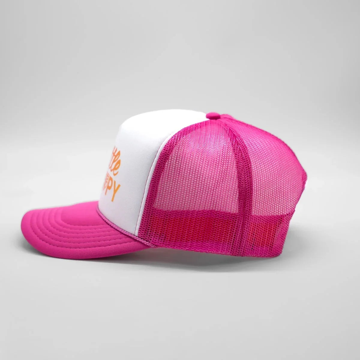 Pink and white cap with mesh design on a light gray background