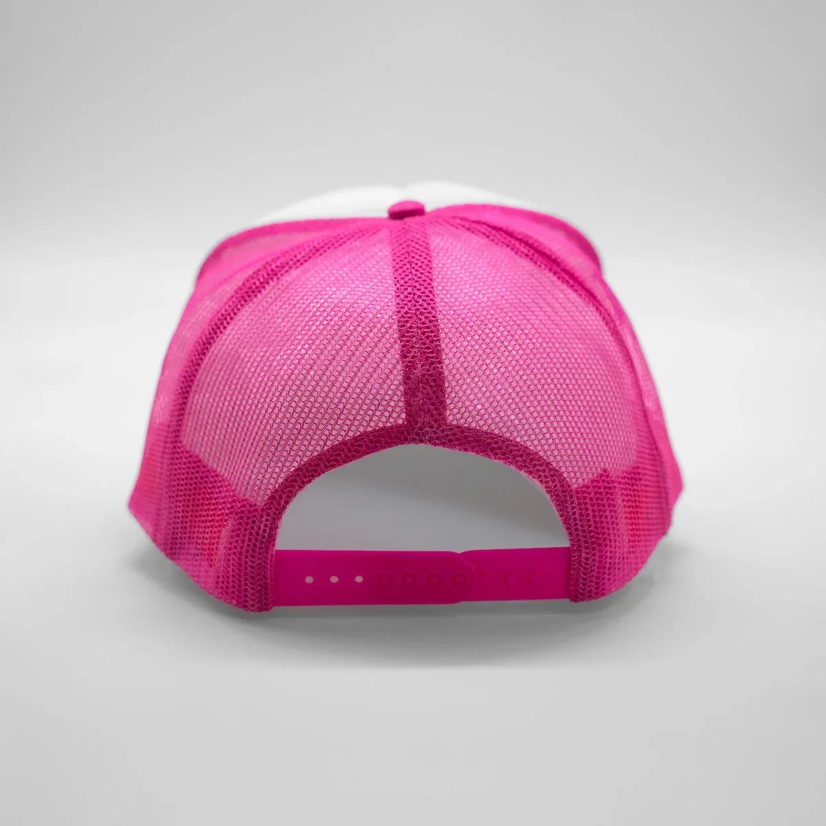 Pink and white cap on a gray background