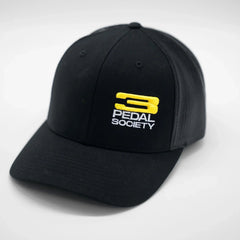 Black cap with yellow and white logo on a light gray background