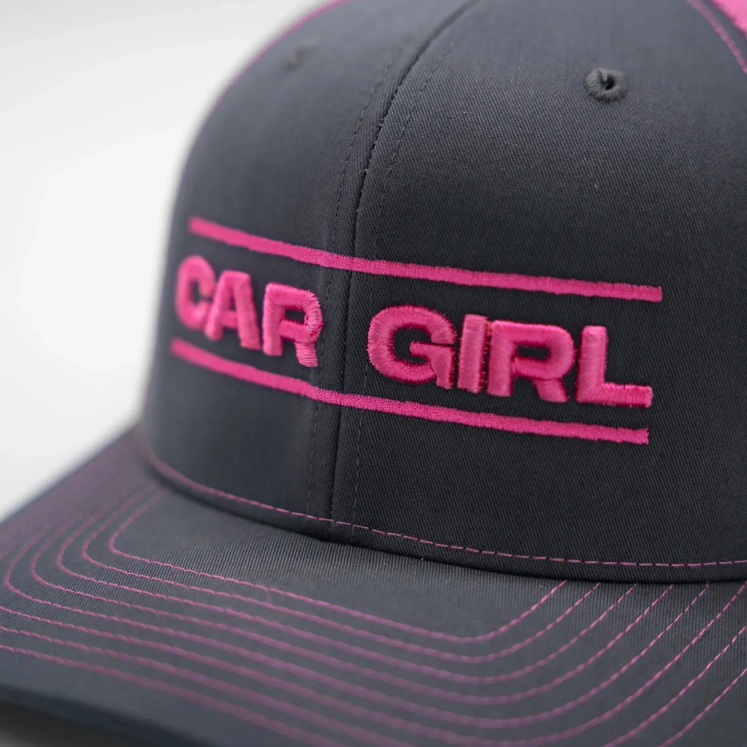 Gray cap with pink 'CAR GIRL' text on a light gray background