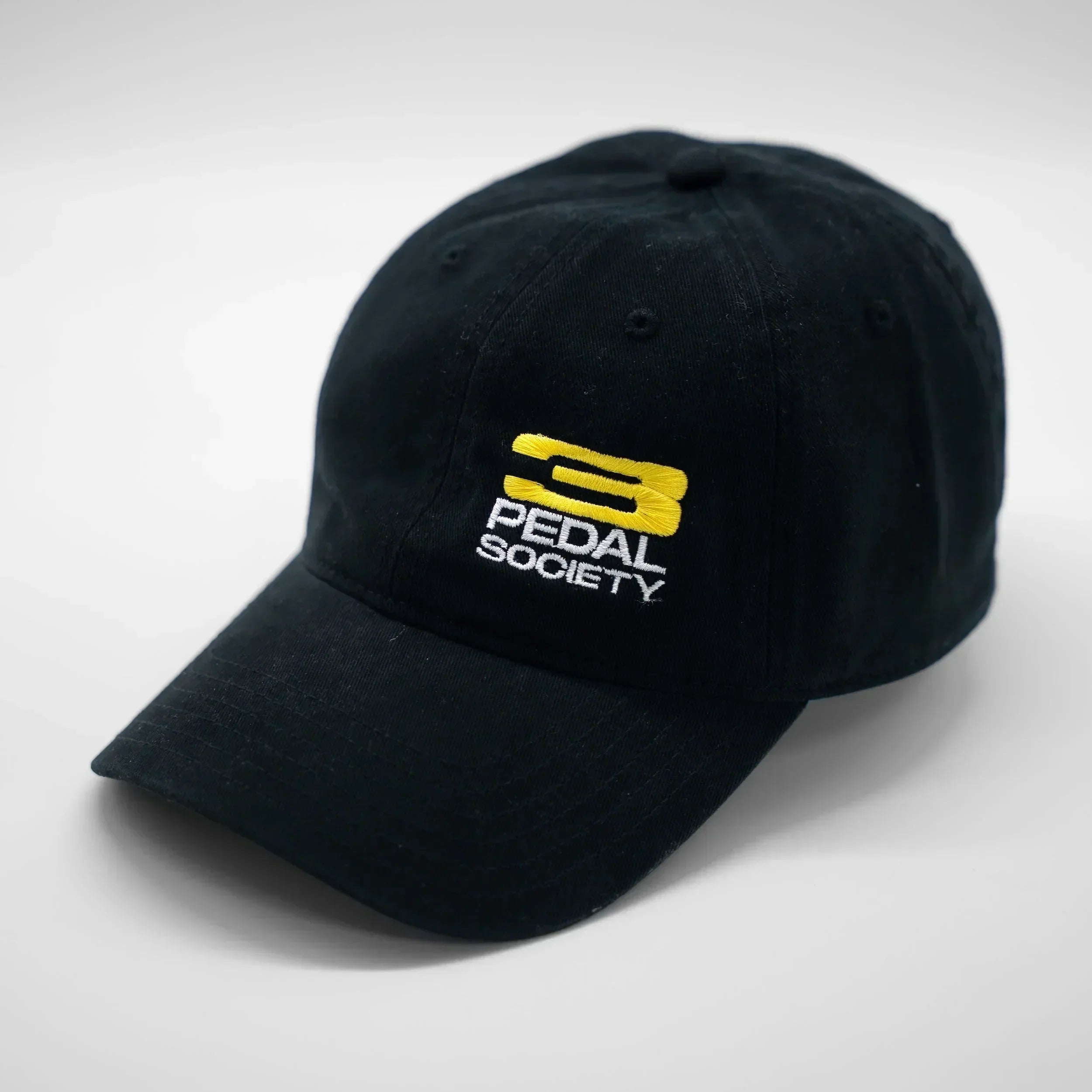 Black cap with 'Pedal Society' logo on a white background