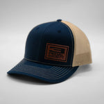 Blue and beige cap with a logo on a gray background