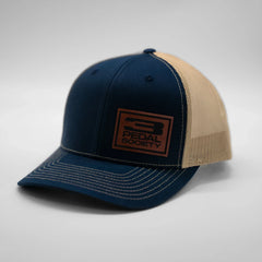Blue and beige cap with a logo on a gray background