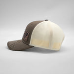 Brown and beige trucker cap on a light gray background