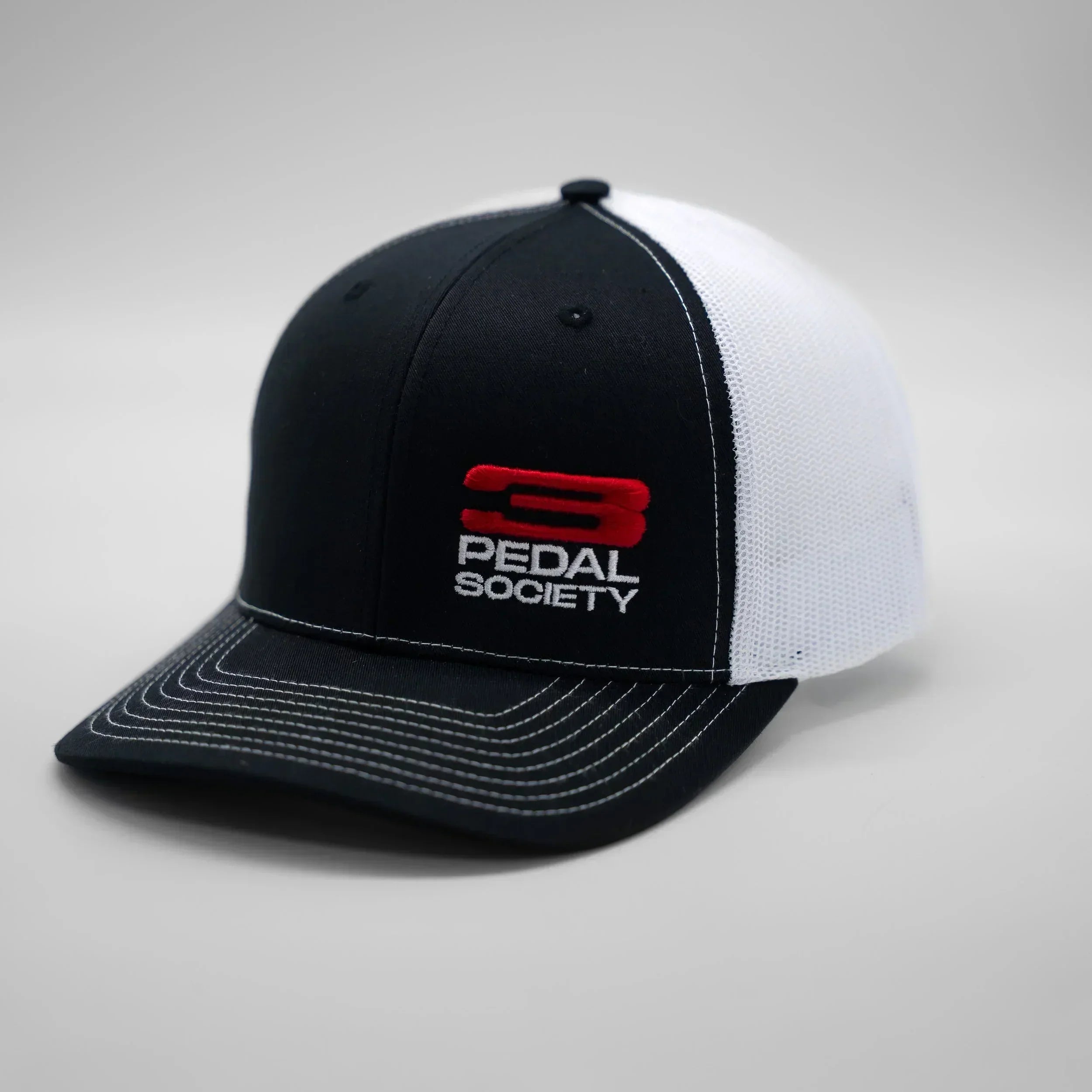 Black and white cap with ' 3 Pedal Society' logo on a gray background