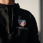 Black hoodie with a logo and text on the chest against a neutral background