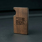 Wooden wallet with '3 Pedal Society' logo on a dark background